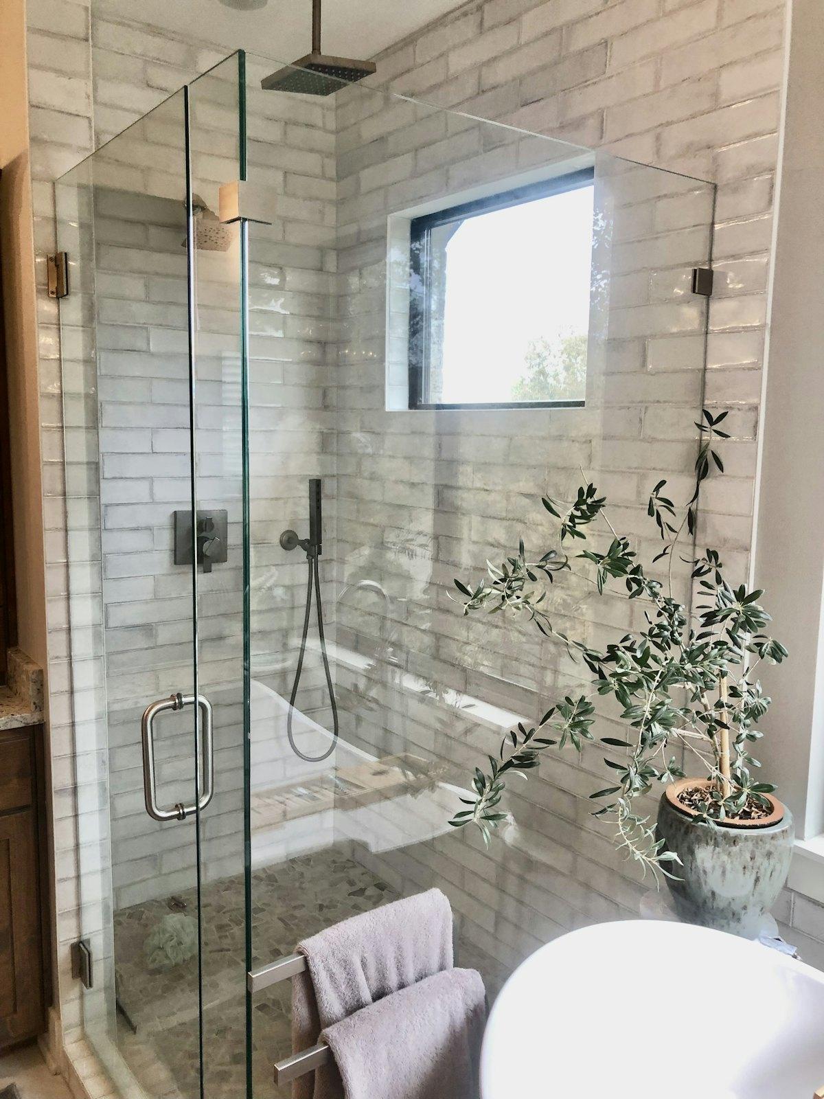 Frameless corner shower with brushed nickel hardware